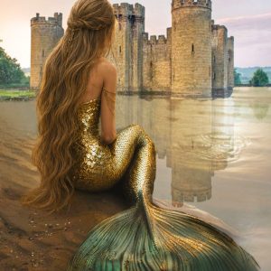 Mermaid with long flowing hair sits on a quiet shoreline facing an ancient castle reflected in still water, evoking a mystical forgotten kingdom.
